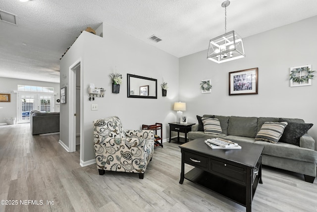 3172 Twilight Ct, Middleburg, FL 32068 - living area featuring light wood-type flooring, a textured ceiling, and a chandelier