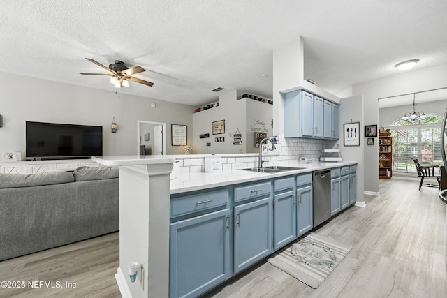 3172 Twilight Ct, Middleburg, FL 32068 - kitchen featuring blue cabinetry, a peninsula, dishwasher, ceiling fan, and a textured ceiling
