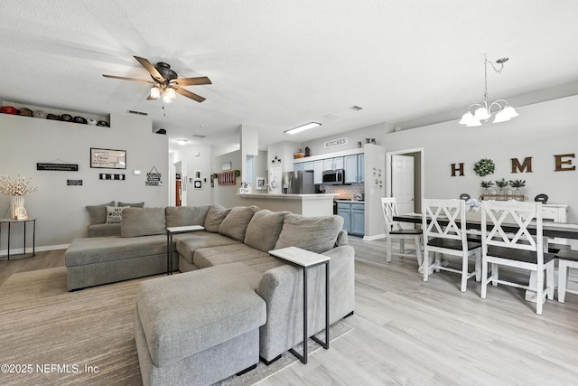 3172 Twilight Ct, Middleburg, FL 32068 - living room featuring ceiling fan, a chandelier, light wood finished floors, and a textured ceiling
