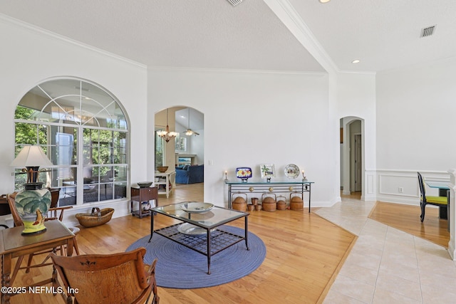 825 Turtle Lake Ct, Ponte Vedra Beach, FL 32082 - living area featuring arched walkways, ornamental molding, light tile patterned flooring, a chandelier, and recessed lighting