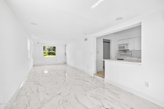 1901 Forest Hills Rd, Jacksonville, FL 32208 - unfurnished living room featuring baseboards and light marble finish flooring