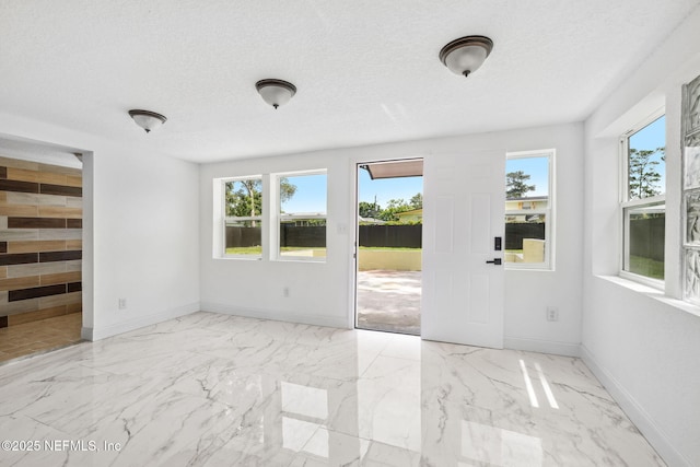 1901 Forest Hills Rd, Jacksonville, FL 32208 - empty room featuring healthy amount of natural light, marble finish flooring, and a textured ceiling