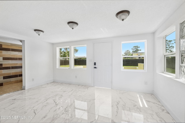 1901 Forest Hills Rd, Jacksonville, FL 32208 - foyer with marble finish floors and a textured ceiling