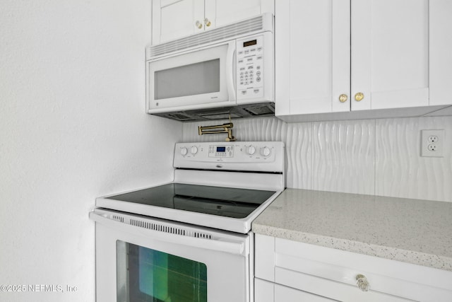 1901 Forest Hills Rd, Jacksonville, FL 32208 - kitchen featuring white appliances, white cabinets, and light stone counters