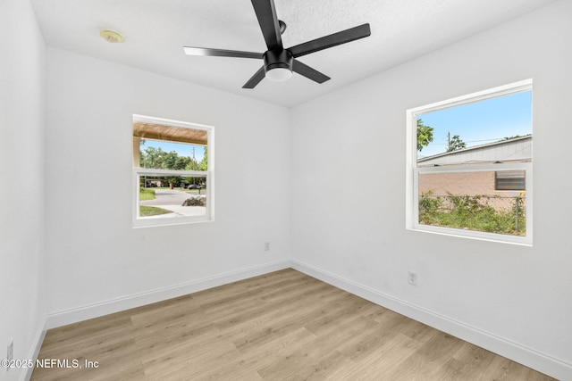 1901 Forest Hills Rd, Jacksonville, FL 32208 - empty room with a smoke detector, light wood-style flooring, and ceiling fan