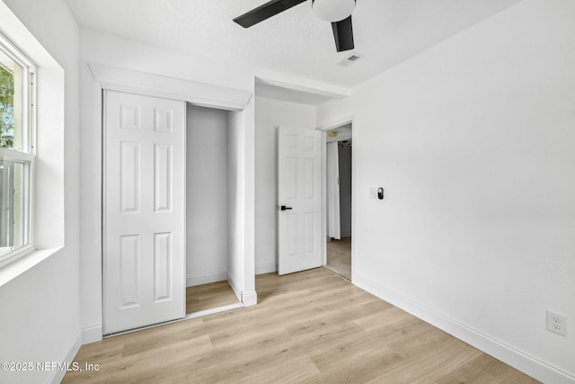 1901 Forest Hills Rd, Jacksonville, FL 32208 - unfurnished bedroom with light wood-style floors, a closet, and a ceiling fan