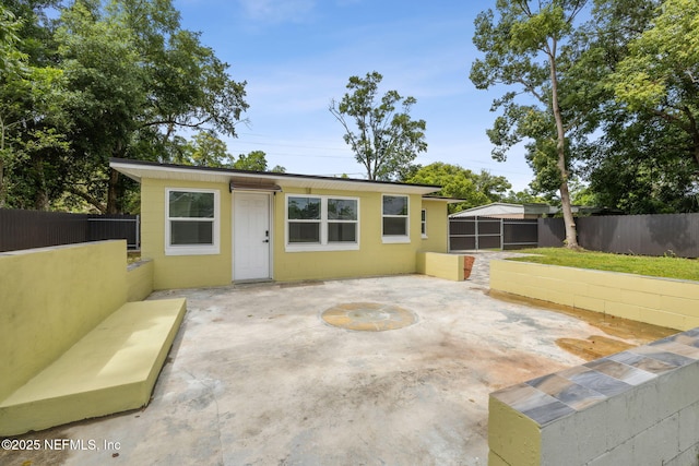 1901 Forest Hills Rd, Jacksonville, FL 32208 - rear view of house featuring a patio and concrete block siding