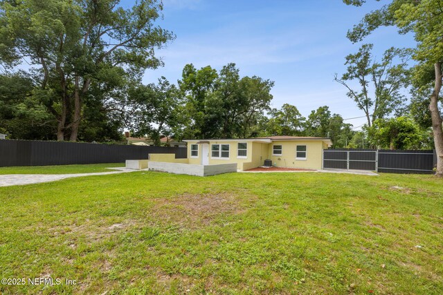 1901 Forest Hills Rd, Jacksonville, FL 32208 - back of property with stucco siding and a patio