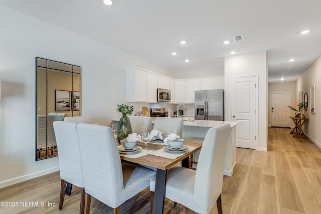 589 Holly Lakes Dr, Orange Park, FL 32073 - dining room featuring light wood-style flooring and recessed lighting
