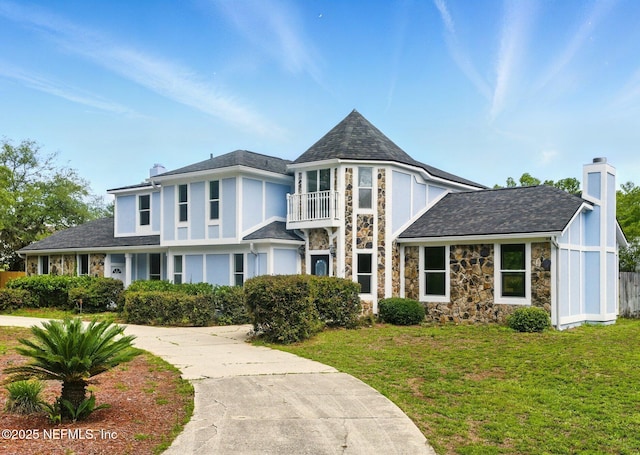 6615 Camelot Ct, Keystone Heights, FL 32656 - view of front of house featuring a chimney, a balcony, stone siding, and driveway