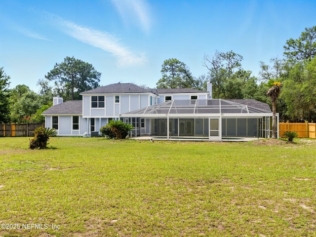 6615 Camelot Ct, Keystone Heights, FL 32656 - back of property featuring a chimney, a fenced backyard, a lanai, and a shingled roof
