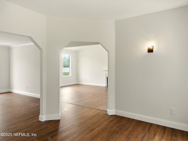 6615 Camelot Ct, Keystone Heights, FL 32656 - empty room with dark wood-style flooring and arched walkways