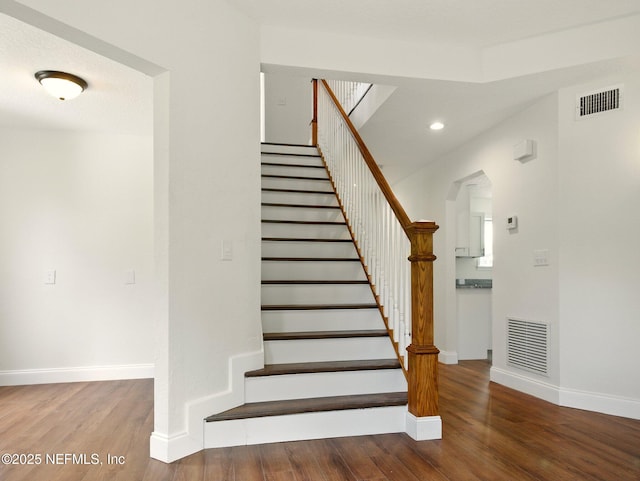 6615 Camelot Ct, Keystone Heights, FL 32656 - stairs with wood finished floors, arched walkways, and recessed lighting