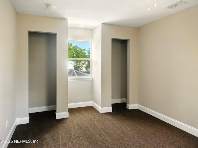 6615 Camelot Ct, Keystone Heights, FL 32656 - unfurnished bedroom featuring dark colored carpet and baseboards