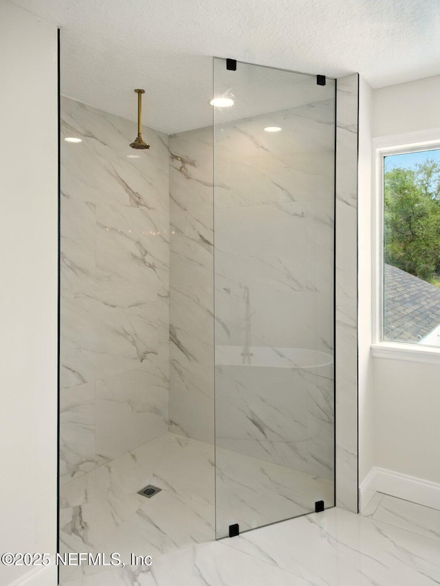 6615 Camelot Ct, Keystone Heights, FL 32656 - bathroom featuring a marble finish shower, marble look tiles, and a textured ceiling