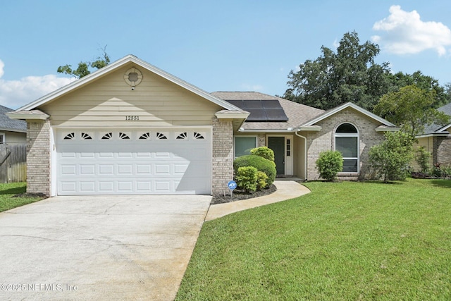 12551 Hunters Branch Way, Jacksonville, FL 32224 - view of front of home with brick siding, a front yard, solar panels, concrete driveway, and a garage