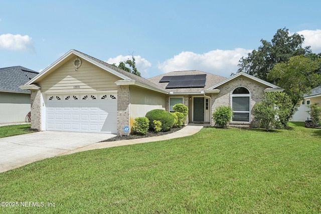 12551 Hunters Branch Way, Jacksonville, FL 32224 - ranch-style house featuring brick siding, an attached garage, solar panels, a front lawn, and driveway