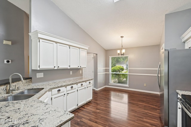 12551 Hunters Branch Way, Jacksonville, FL 32224 - kitchen with lofted ceiling, white cabinetry, light stone countertops, dark wood-type flooring, and a chandelier