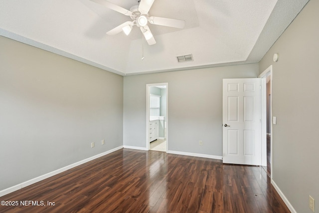 12551 Hunters Branch Way, Jacksonville, FL 32224 - unfurnished bedroom with dark wood-style floors, a ceiling fan, and connected bathroom