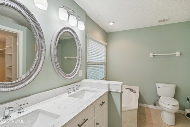 12551 Hunters Branch Way, Jacksonville, FL 32224 - bathroom featuring a garden tub, double vanity, tile patterned floors, and a textured ceiling