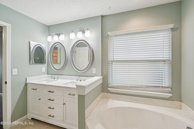 12551 Hunters Branch Way, Jacksonville, FL 32224 - bathroom featuring a garden tub, double vanity, a textured ceiling, and tile patterned flooring