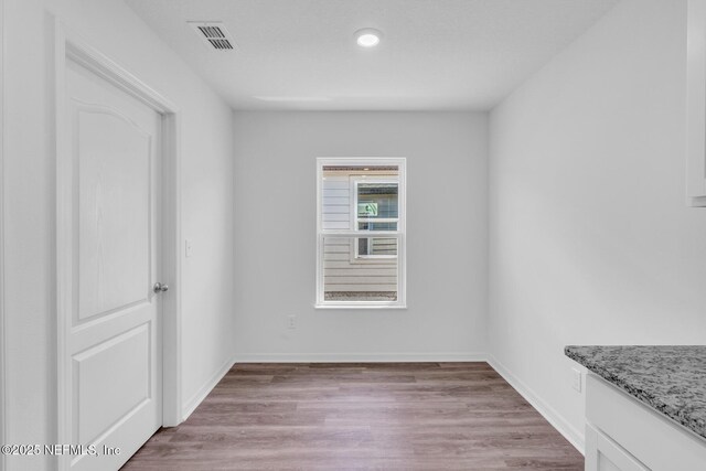 37119 Whippoorwill Ct, Hilliard, FL 32046 - empty room featuring light wood finished floors and recessed lighting