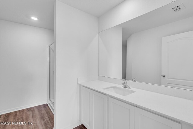 37119 Whippoorwill Ct, Hilliard, FL 32046 - full bathroom with vanity, wood finished floors, a stall shower, and recessed lighting