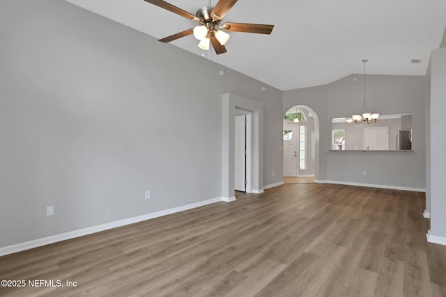 732 Putters Green Way, Saint Johns, FL 32259 - unfurnished living room with a chandelier, high vaulted ceiling, a ceiling fan, arched walkways, and wood finished floors