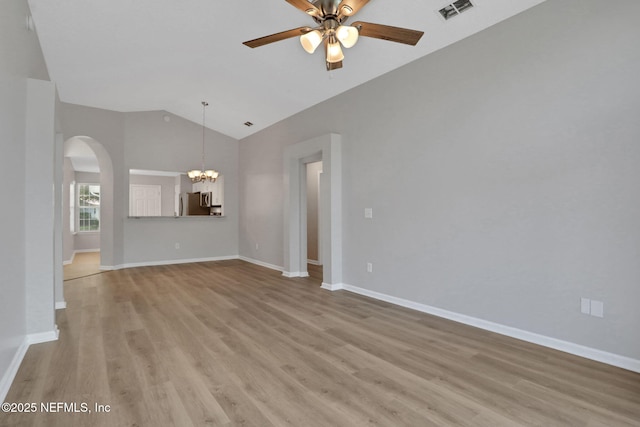 732 Putters Green Way, Saint Johns, FL 32259 - unfurnished living room featuring light wood-style flooring, ceiling fan, arched walkways, a chandelier, and high vaulted ceiling