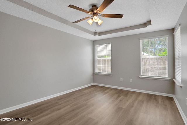 732 Putters Green Way, Saint Johns, FL 32259 - spare room featuring wood finished floors, a textured ceiling, ceiling fan, and a tray ceiling