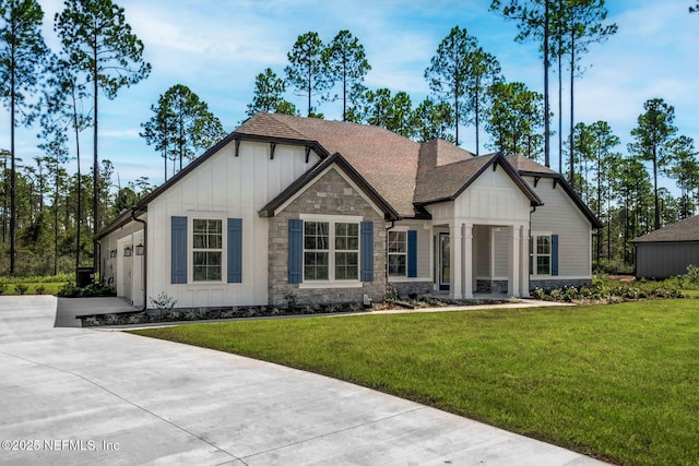 36295 Pitch Ln, Hilliard, FL 32046 - view of front facade featuring board and batten siding, stone siding, and a front yard