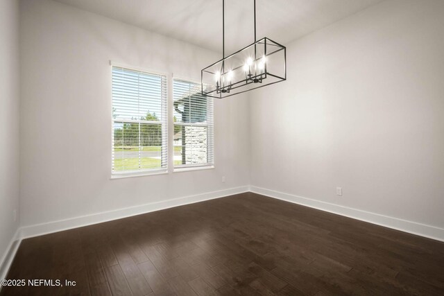 36295 Pitch Ln, Hilliard, FL 32046 - unfurnished dining area with a chandelier and dark wood-type flooring