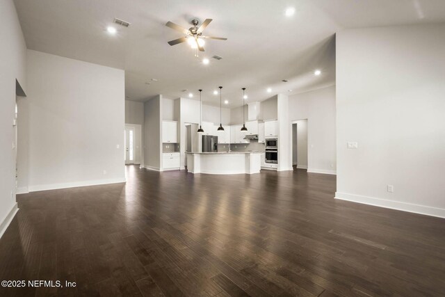 36295 Pitch Ln, Hilliard, FL 32046 - unfurnished living room featuring ceiling fan, recessed lighting, dark wood finished floors, and high vaulted ceiling