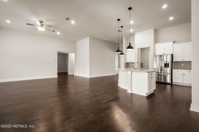 36295 Pitch Ln, Hilliard, FL 32046 - kitchen featuring stainless steel refrigerator with ice dispenser, ceiling fan, open floor plan, recessed lighting, and a towering ceiling