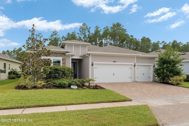 37 Tobago Ln, Saint Augustine, FL 32092 - view of front of property featuring an attached garage, decorative driveway, a front yard, and roof with shingles