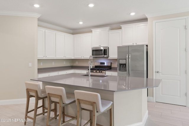37 Tobago Ln, Saint Augustine, FL 32092 - kitchen with stainless steel appliances, recessed lighting, a kitchen bar, an island with sink, and white cabinetry