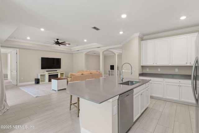 37 Tobago Ln, Saint Augustine, FL 32092 - kitchen with stainless steel dishwasher, arched walkways, a ceiling fan, an island with sink, and white cabinets