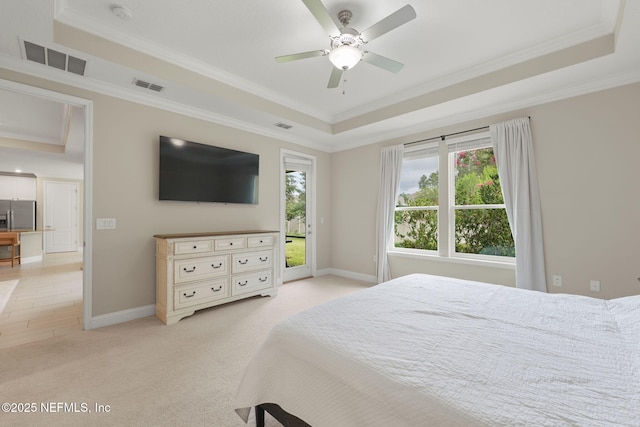 37 Tobago Ln, Saint Augustine, FL 32092 - bedroom with a raised ceiling, light colored carpet, ornamental molding, stainless steel fridge, and access to exterior