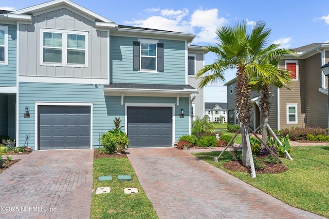 67 Carmella Ct, Saint Augustine, FL 32092 - townhome / multi-family property with board and batten siding, driveway, and an attached garage