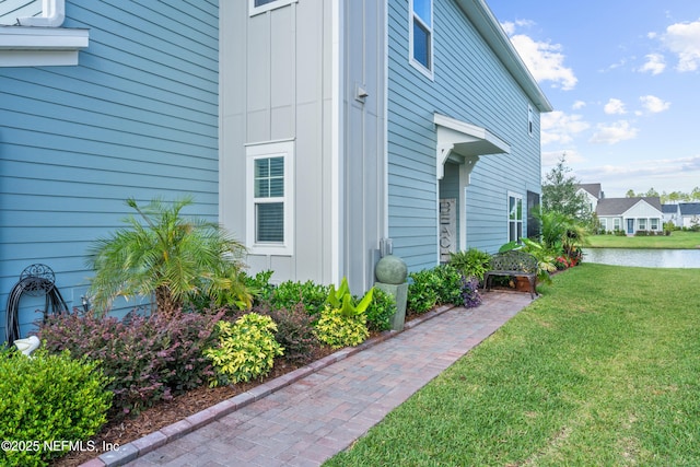 67 Carmella Ct, Saint Augustine, FL 32092 - view of side of home featuring a yard, a water view, and board and batten siding