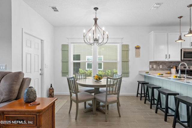 67 Carmella Ct, Saint Augustine, FL 32092 - dining space featuring a chandelier and baseboards