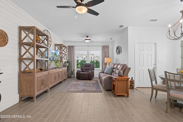 67 Carmella Ct, Saint Augustine, FL 32092 - living room with ceiling fan, light wood finished floors, and a textured ceiling