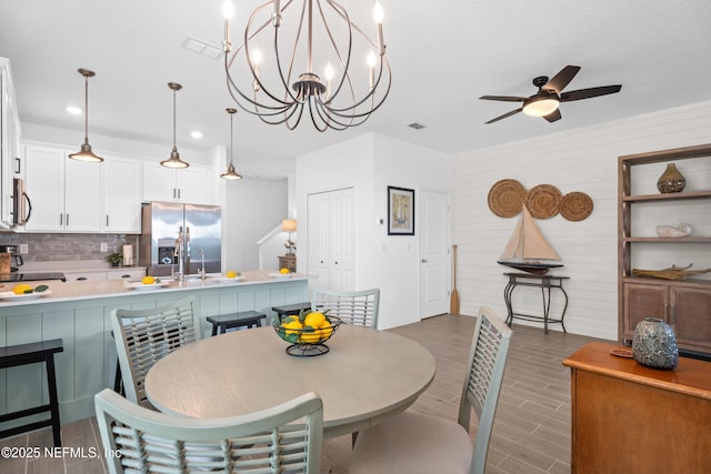 67 Carmella Ct, Saint Augustine, FL 32092 - dining space with dark wood-style floors, a ceiling fan, recessed lighting, and a chandelier