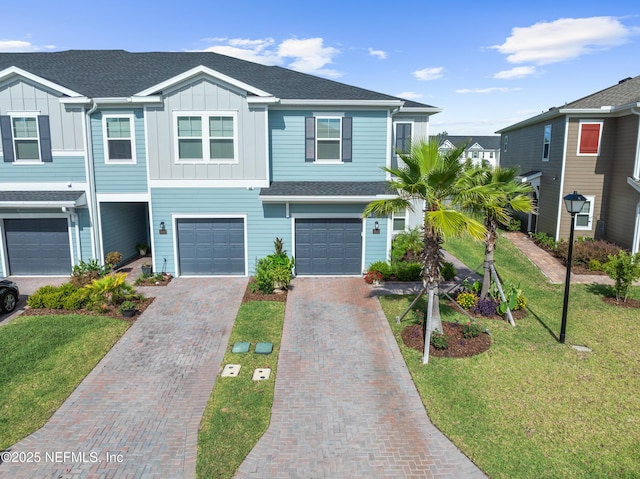 67 Carmella Ct, Saint Augustine, FL 32092 - view of front facade featuring board and batten siding, driveway, an attached garage, and a front lawn