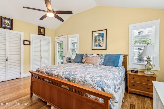 111 S 4th St, Fernandina Beach, FL 32034 - bedroom featuring vaulted ceiling, multiple windows, light wood-style flooring, and multiple closets