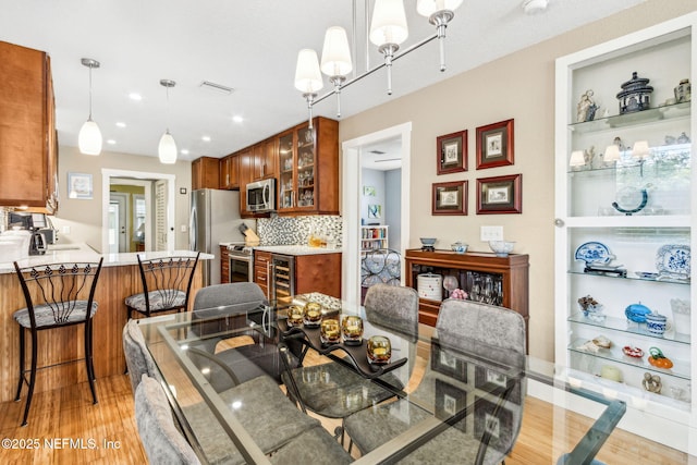 111 S 4th St, Fernandina Beach, FL 32034 - dining space with light wood-style flooring, recessed lighting, and a chandelier