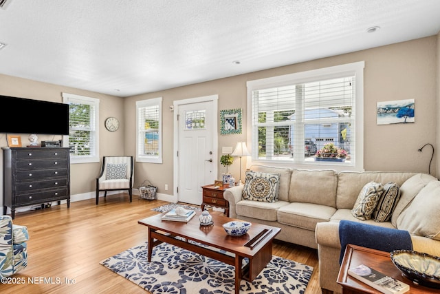 111 S 4th St, Fernandina Beach, FL 32034 - living area featuring light wood finished floors and a textured ceiling