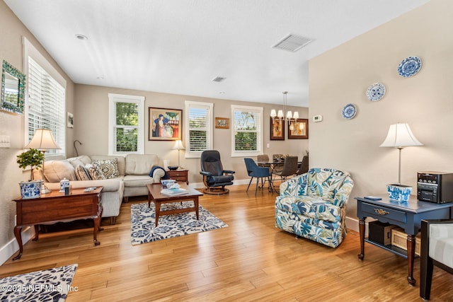 111 S 4th St, Fernandina Beach, FL 32034 - living room featuring a chandelier and light wood-type flooring