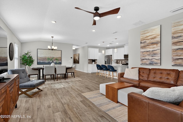 204 Bryson Dr, Fruit Cove, FL 32259 - living room featuring a ceiling fan, a chandelier, light wood finished floors, recessed lighting, and lofted ceiling