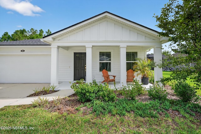 204 Bryson Dr, Fruit Cove, FL 32259 - view of front facade with a porch, board and batten siding, a garage, concrete driveway, and roof with shingles